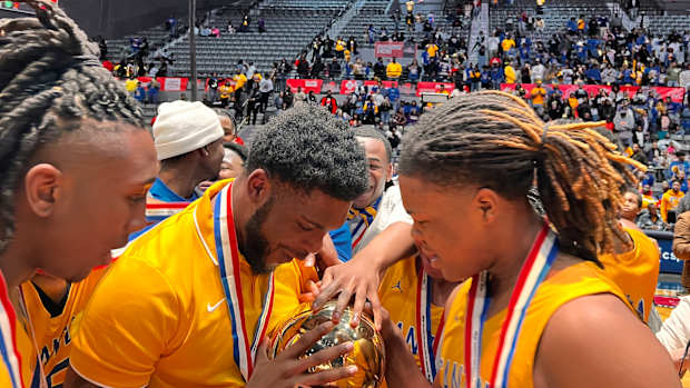The Canton Tigers celebrate the 2024 MHSAA Class 5A State Championship after defeating Yazoo City 58-40 on March 1 at the Mississippi Coliseum.